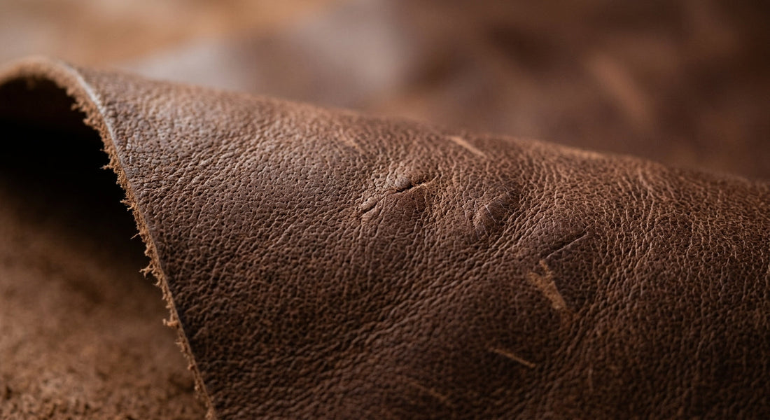Macro of full-grain leather showing natural pore structure and irregular grain.
