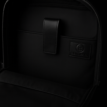 Close-up of a black backpack with a brand logo on a black background