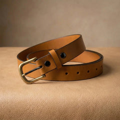 Bellvari Buckhorn leather belt coiled, showing rich tan tone and antique-brass buckle. — view 5
