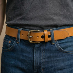 Bellvari Buckhorn leather belt worn full-length view, antique-brass buckle. — view 7