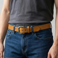 Bellvari Buckhorn leather belt worn with jeans, antique-brass buckle close-up. — view 3