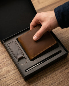 Hand lifting the leather wallet from the gift box — view 8