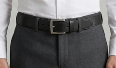 The Draftsman belt fastened at the waist over charcoal wool trousers. — view 6