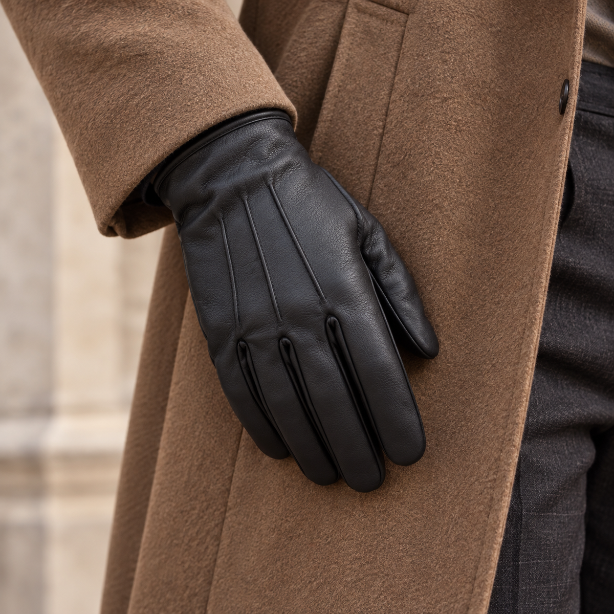 Black glove worn with a camel coat