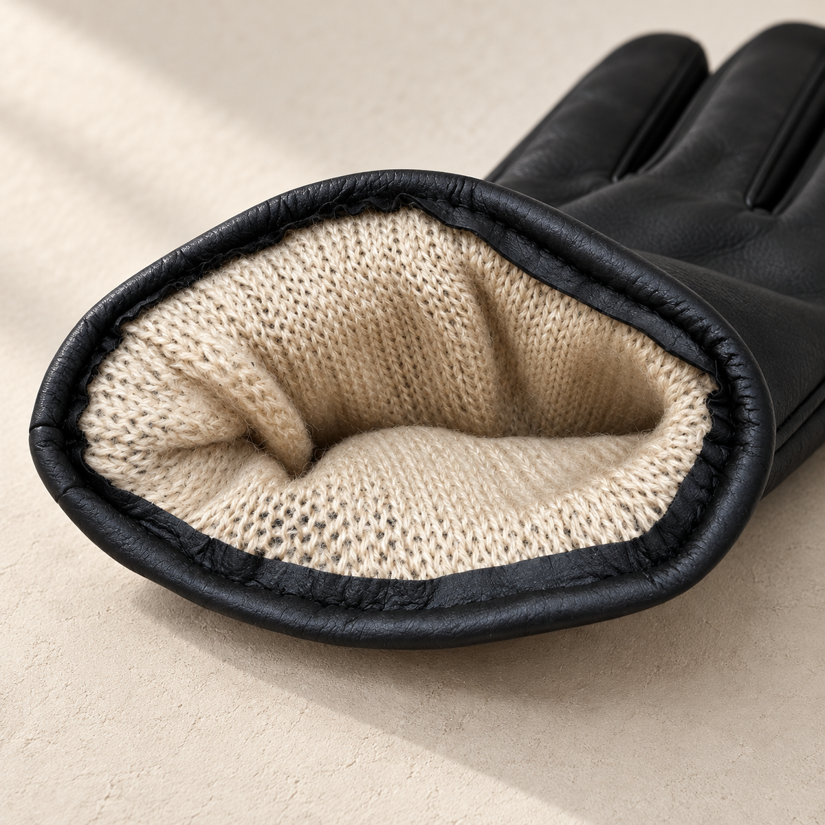 Beige knit lining inside black glove