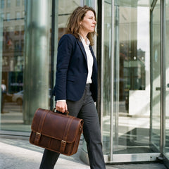 A woman carrying the Bellvari leather messenger briefcase into an office. — view 8